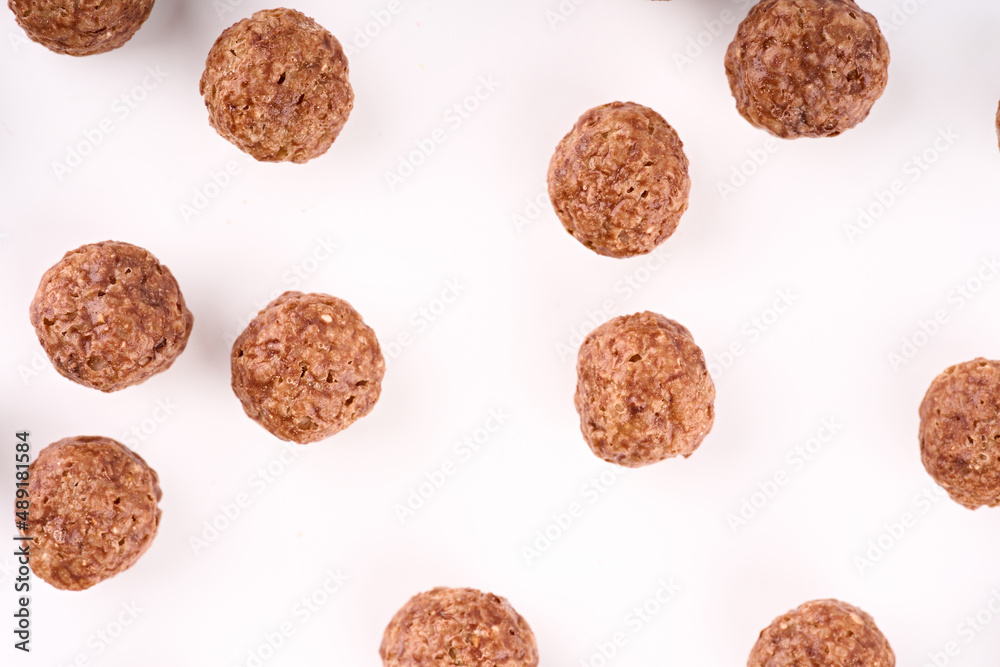 Variety of cold cereals, quick breakfast for kids overhead shot. Quick breakfast. Chocolate balls isolated on a white background. Rings isolated on a white background. Variety of cold cereals, quick breakfast for kids overhead shot. Quick breakfast. Chocolate balls isolated on a white background. Rings isolated on a white background.