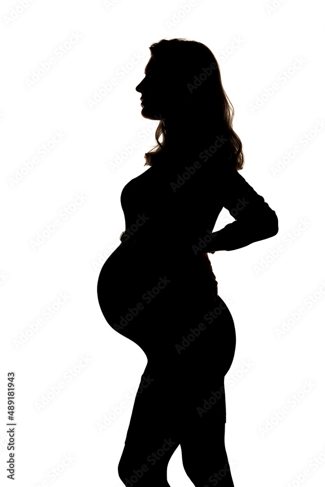 Silhouette of a pregnant woman posing in studio