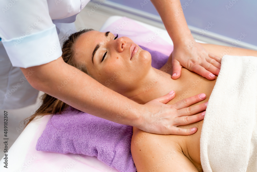 Facial massage. A woman is given a massage in a beauty salon. Close-up. Facial massage. A woman is given a massage in a beauty salon. Close-up.