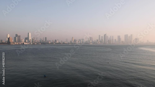 Wide angle real time still video of beautiful city skyline of Mumbai during sunset. Smoggy view of Bombay skyline from Bandra Reclamation promenade during a summer evening. Maharashtra, India. 5147. photo