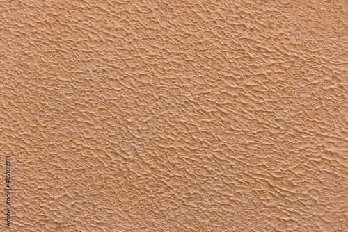 Brown coffee light color plaster wall abstract pattern coarse surface rough texture stucco background