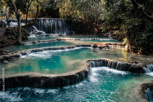 Amazing turquoise water of Kuang Si waterfall in tropical rain forest. Laos © Maksim