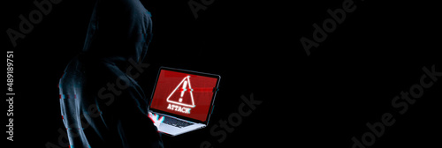 Cyber hacker attack concept. Internet web hack technology. Blurred Digital laptop in hacker man hand isolated on black with glitch effect. Information security terms cybersecurity banner.