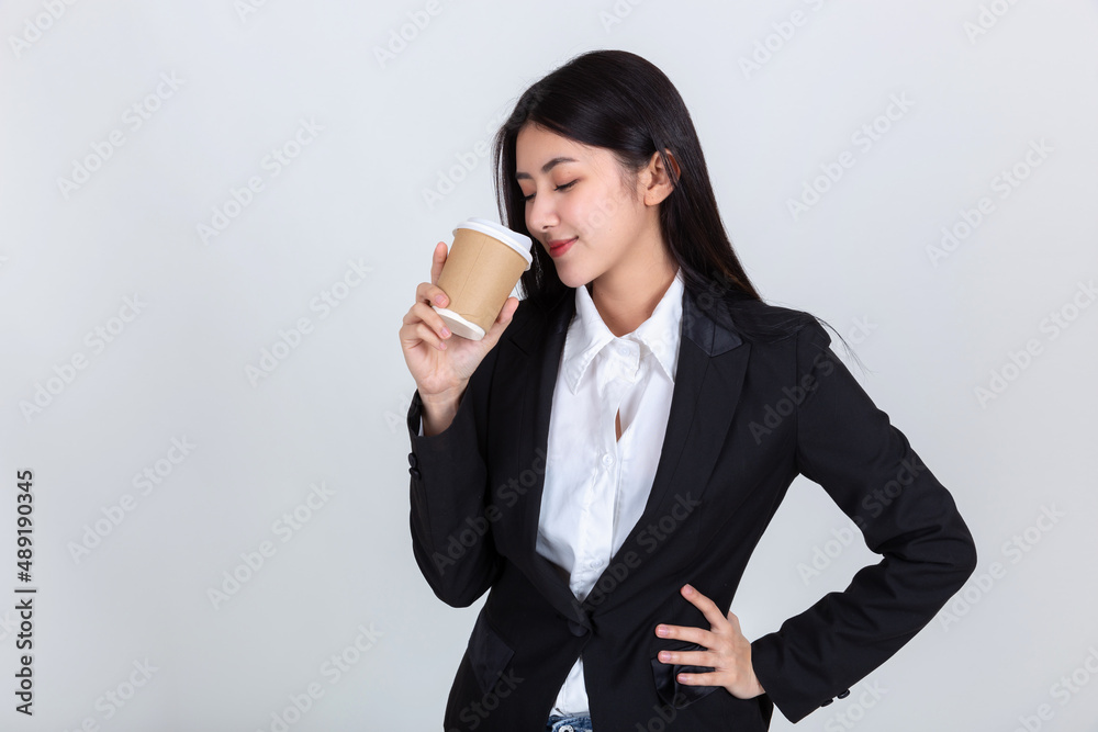 Entrepreneur pretty young asian woman ,Beautiful attractive asian business woman wearing black suit smile feeling happy holding coffee cup with copy space for your promotional or text. Entrepreneur pretty young asian woman ,Beautiful attractive asian business woman wearing black suit smile feeling happy holding coffee cup with copy space for your promotional or text.