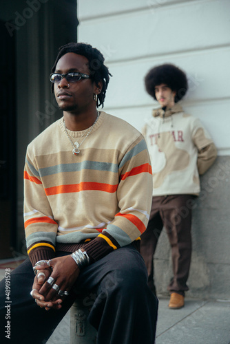 Gay couple sitting outside.