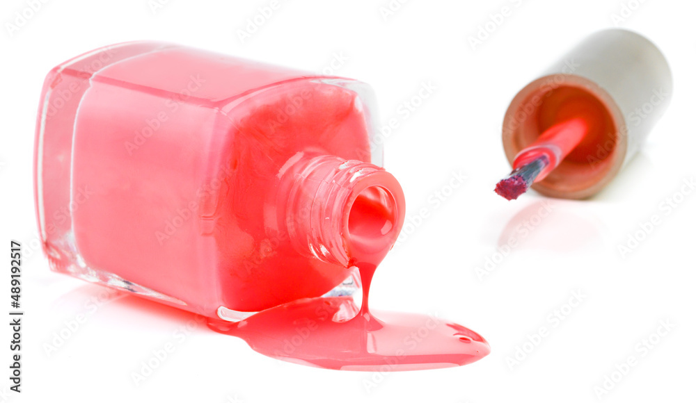Dont cray over spilt varnish. Studio shot of bottle lying sideways spilling out nail varnish. Dont cray over spilt varnish. Studio shot of bottle lying sideways spilling out nail varnish.