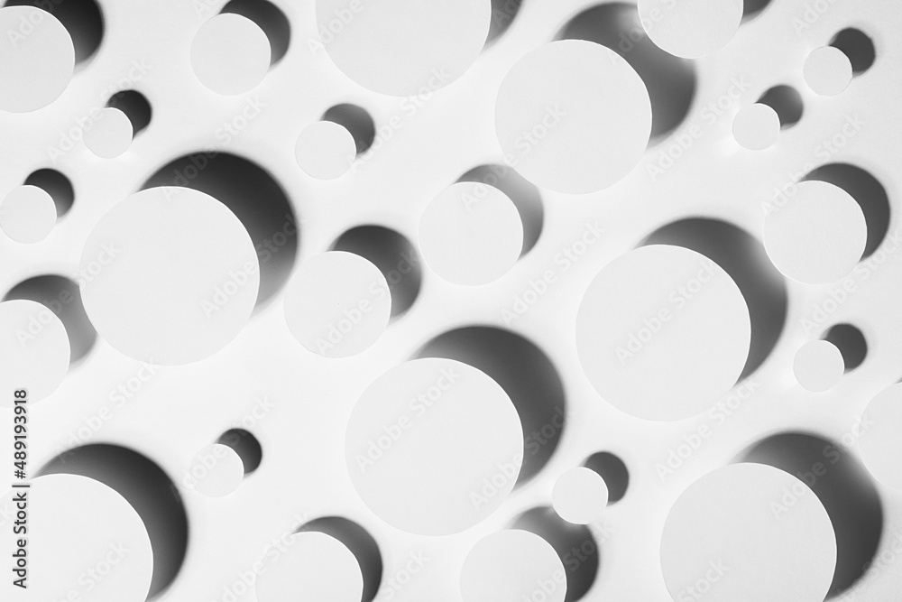 White simple geometric background with flying circles in shine hard light with contrast black shadows, glare as energy stable pattern, top view. Futuristic minimal backdrop for advertising, design.