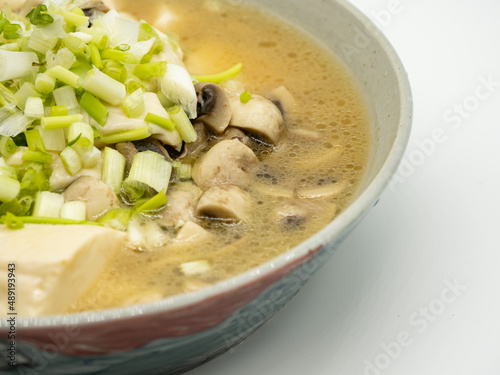 A bowl of shallot, tofu and mushroom soup
