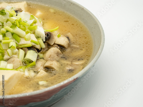A bowl of shallot, tofu and mushroom soup