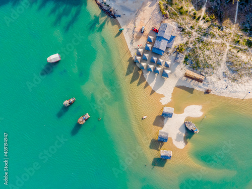 Fototapeta Naklejka Na Ścianę i Meble -  Bird's eye view on beach scenery with turquoise ocean and beach bar in Brazil Ceara