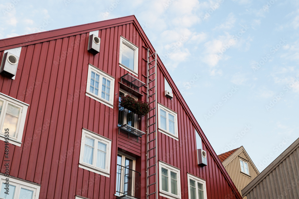Wall of red wooden house with windows