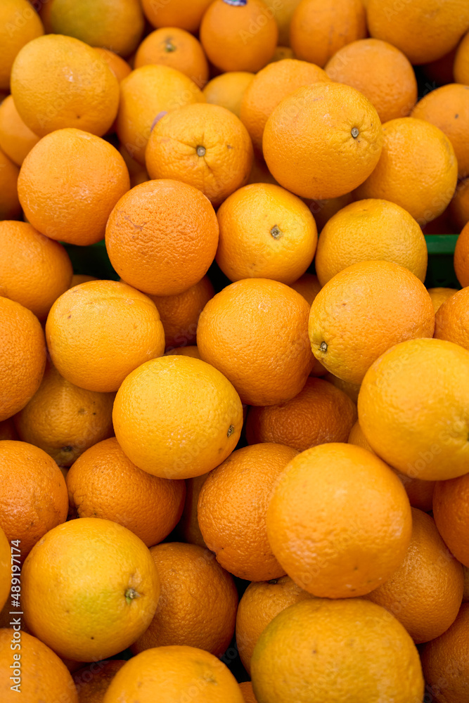 Tangerine background. Citrus fruit. Natural remedy for colds. Vegetarian food. Fresh mandarin oranges fruit or tangerines with leaves, as background.