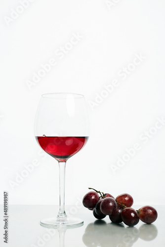 Glass with red wine and grape beautiful still life