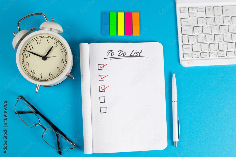 To do list in notebook plan. Top view, flat lay, copy space.