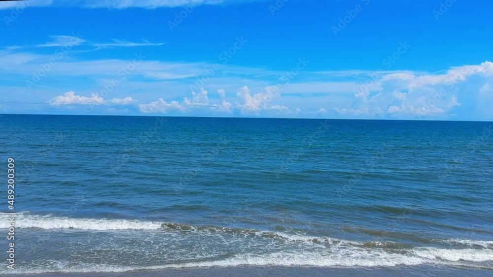 Deep blue ocean and sky reveals waves and beach Deep blue ocean and sky reveals waves and beach
