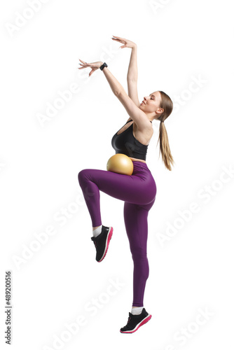 Slender girl gymnast in black sportswear with Isolated on a white background. © ksi
