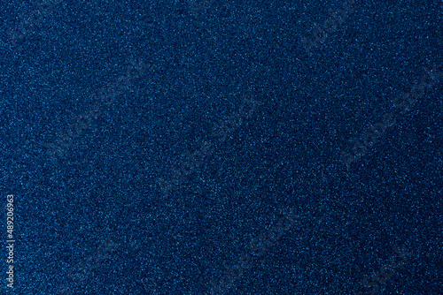 Dark blue, shiny and glittering surface. Abstract background. Events, celebrations. Trendy backdrop for your design. Texture with glitter.