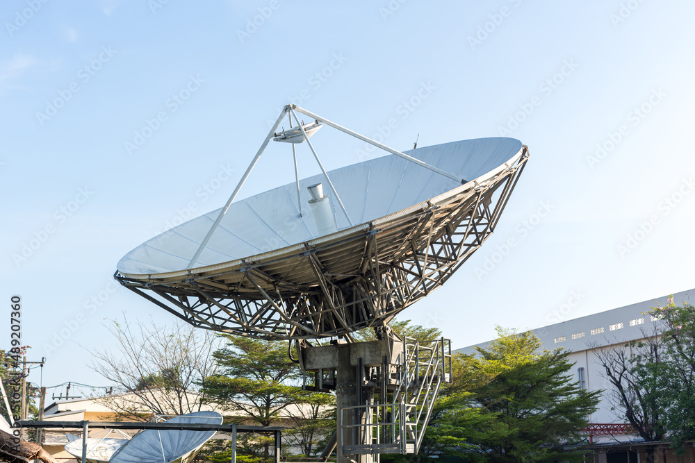 satellite dish radar antenna station in field. parabolic antennas. Big parabolic antenna against sky. Satellite dish at earth station with a sky.