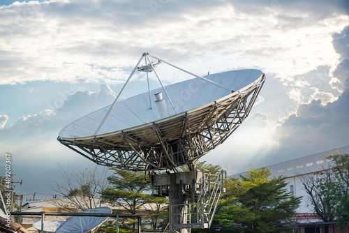 satellite dish radar antenna station in field. parabolic antennas. Big parabolic antenna against sky. Satellite dish at earth station with a sky. photo