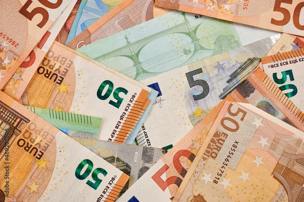 Obraz premium Dollars and Euro banknotes - photo of real money. Dollars and Euro as background for financial concept. Commercial result of trading. Real money for productive business. EUR paper. Fiat currency.