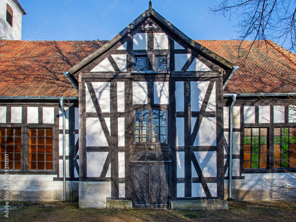 Obraz premium General view and close-up of architectural details of the post-Evangelical, now Catholic, historic church of Christ the King built in 1734 in the town of Jerutki in Masuria, Poland.