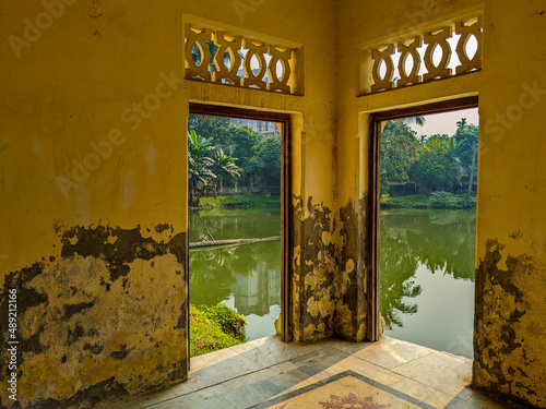 A lake visible through the walls of the Shashi Lodge in the Mymensingh region in Bangladesh photo