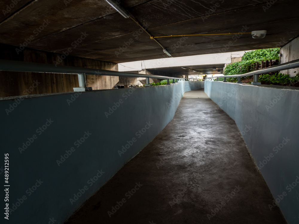 Fototapeta premium underpass walkway under the street beside the drainage canal
