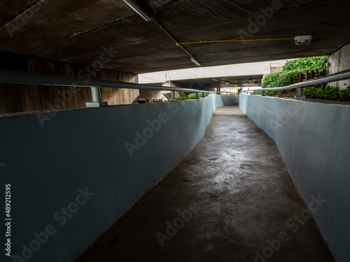 underpass walkway under the street beside the drainage canal