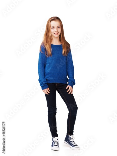 Shes laid-back and relaxed. Full body portrait of a pretty young girl standing against a white background.