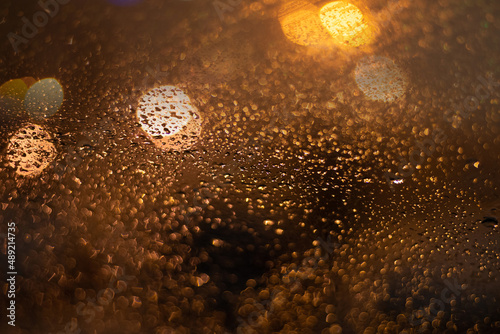 Blurred background with raindrops and lights.