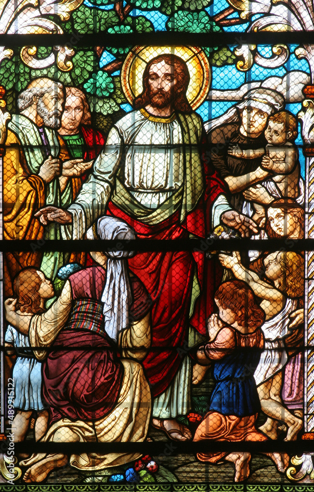 Jesus blesses mothers with children, stained glass window in the Saint John the Baptist church in Zagreb, Croatia