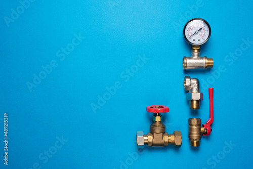 Plumbing equpment and accessories parts on the blue flat lay background with copy space. Pipeline parts. photo