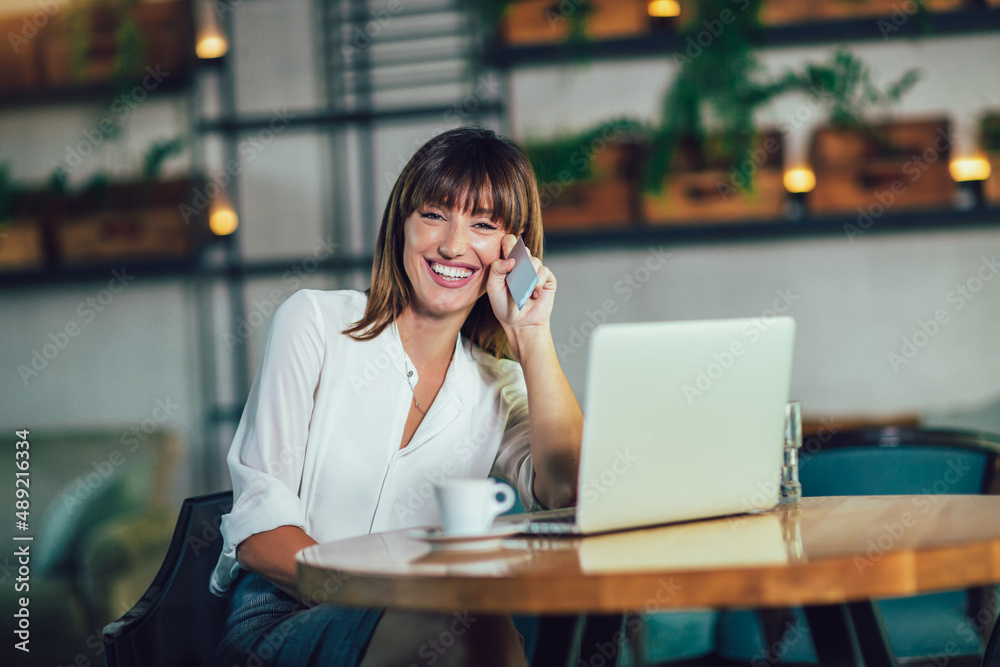 Young woman sitting in cafeteria and perform online shopping Young woman sitting in cafeteria and perform online shopping