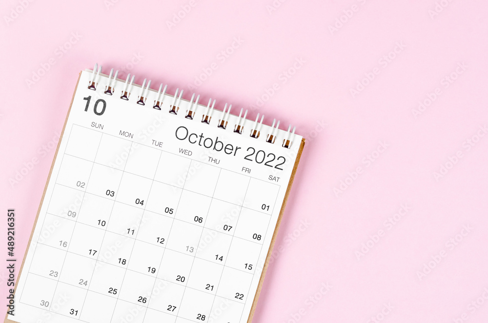 October 2022 desk calendar on pink background with empty space. October 2022 desk calendar on pink background with empty space.