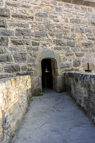 Vertical shot of a small arch in the the Stoeberlein Tower in Rothenburg ob der Tauber, Germany photo