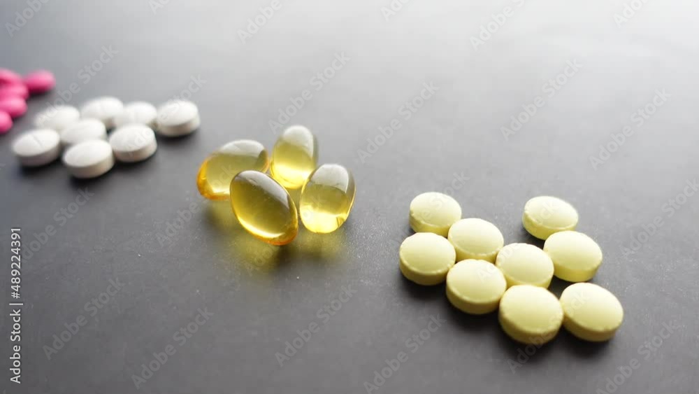 Close up of many colorful pills and capsules on black background Close up of many colorful pills and capsules on black background