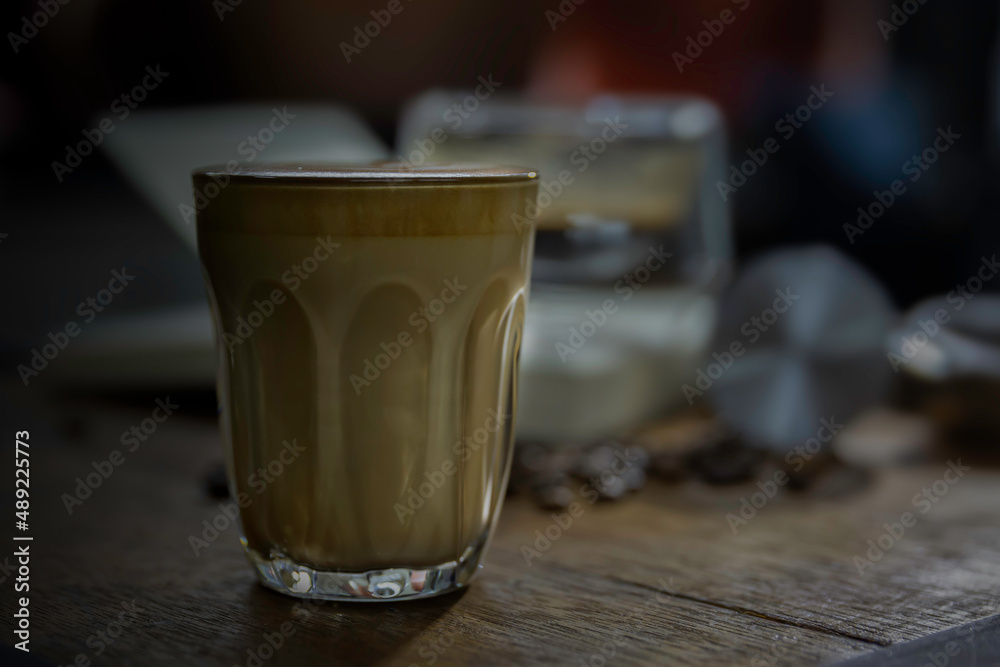clear cup of coffee put on brown wooden table. clear cup of coffee put on brown wooden table.