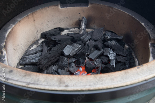Lit lump charcoal inside a grill.