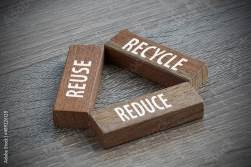 Recycle concept. Recycle, reuse, and reduce wording engrave on wooden cube