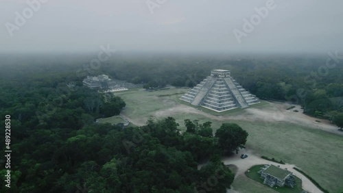 Drone flying over Chichen Itza Pyrmid Foggy Fog Morning Clouds Mayan Civilization photo