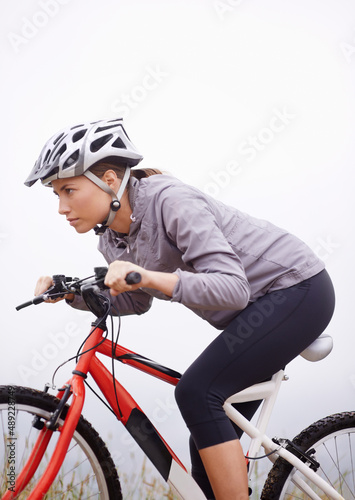 Its alwa. Shot of a female mountain biker out for an early morning ride.