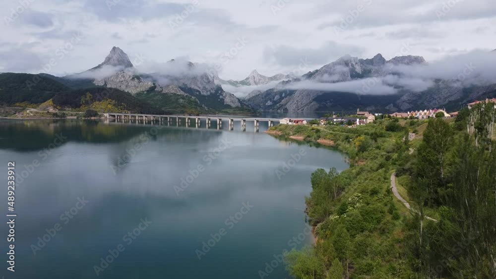 Riaño, Castile and Leon, Spain - Aerial Drone View of the Famous Bridge, Cloudy Mountains and Water (Mirror) Reservoir at Nature Park Montaña de Riaño and Mampodre Riaño, Castile and Leon, Spain - Aerial Drone View of the Famous Bridge, Cloudy Mountains and Water (Mirror) Reservoir at Nature Park Montaña de Riaño and Mampodre