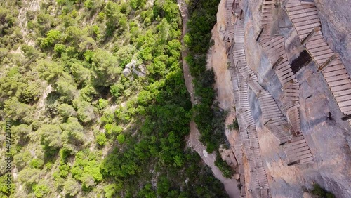 Pasarelas de Montfalco at Congost de Mont Rebei Canyon, Catalonia and Aragon, North Spain - Aerial Drone View (Pan Down) of the Dangerous Scary Stairs and Hike Trail along the Steep Cliffs photo