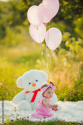 child with balloons in nature