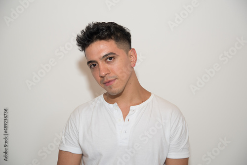 nice guy, dark-haired, white test, white t-shirt, looking to the side, with neutral background