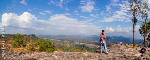 Tourists watch the atmosphere, sky and clouds above the Mekong mountain at Pha Chanadai. Ubon Ratchathani, Thailand photo