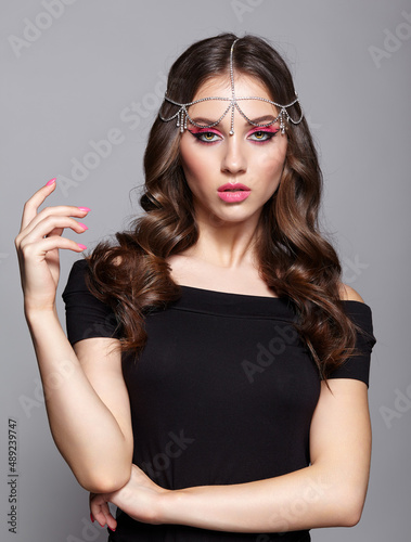 Beauty portrait of young woman. Brunette girl with evening female makeup and black T-shirt