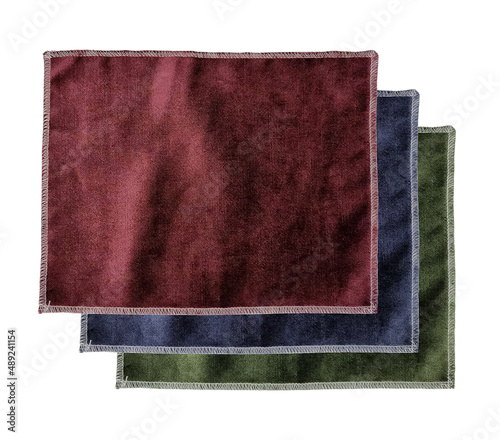 stacked of velvet fabric samples in red, blue and green color isolated on background with clipping path. drapery samples palette for selection. interior luxury materials. photo