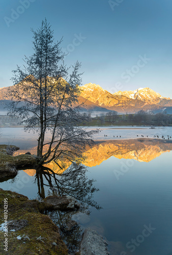 reflections of mountains in the water of a lake in winter. Ritzensee in Saalfelden in Salzburger Land