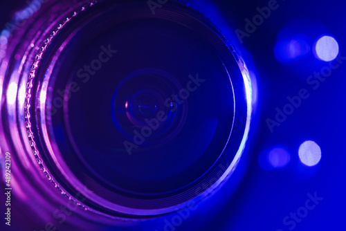 Camera lens with purple and blue backlight. Optics. Cyberpunk style